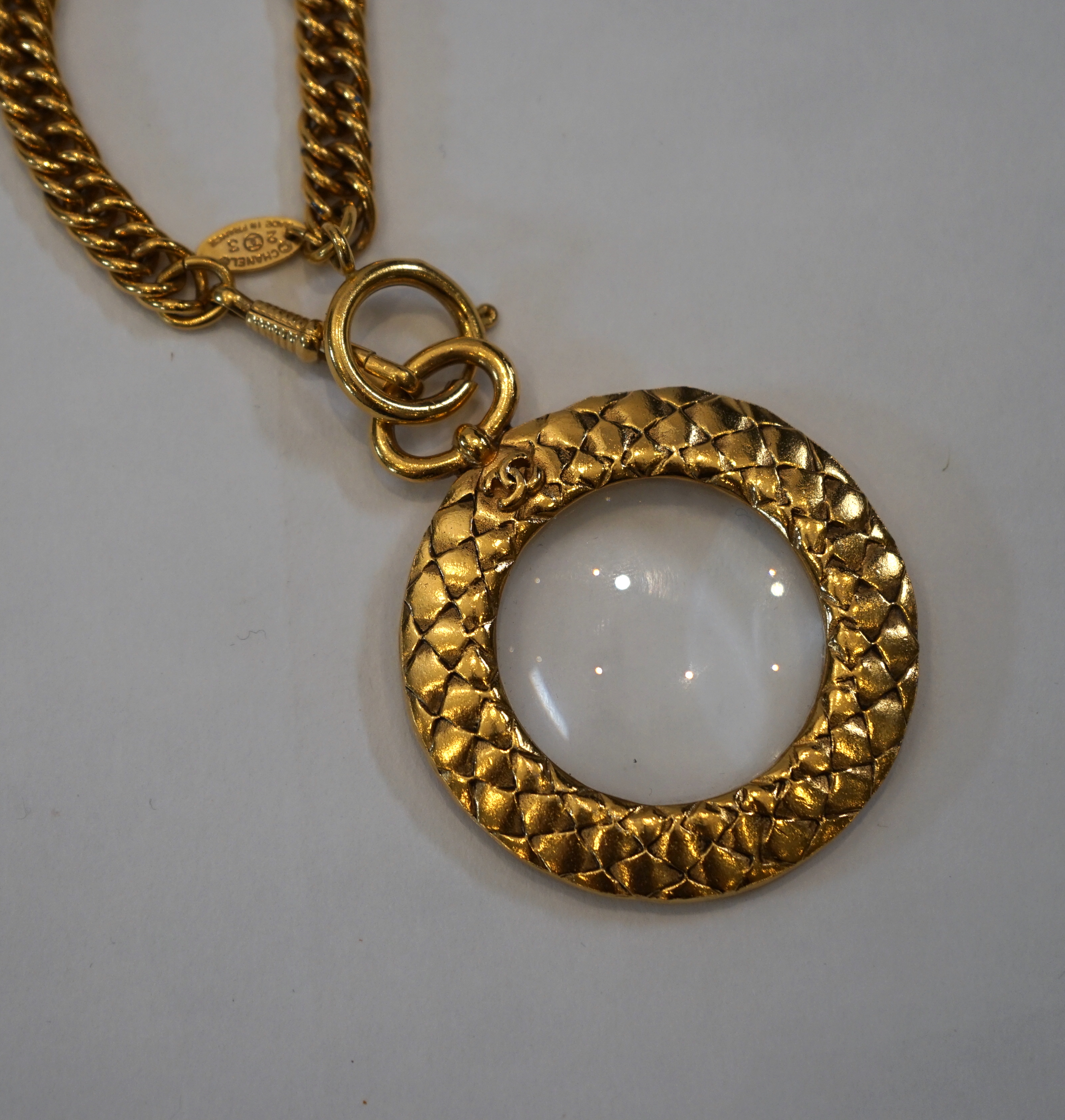 A 1980s Chanel gilt metal 'Scales Textured' magnifying loupe necklace chain length 900mm, pendant width 66mm, height 52mm